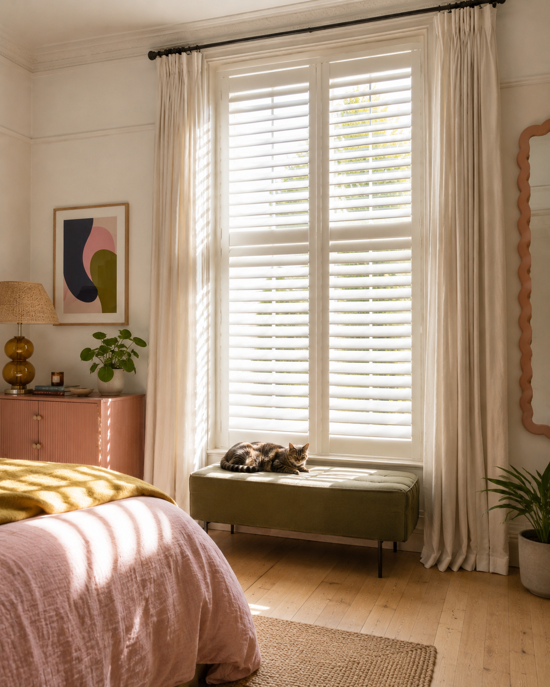Full height white shutters fitted to a tall period sash window
